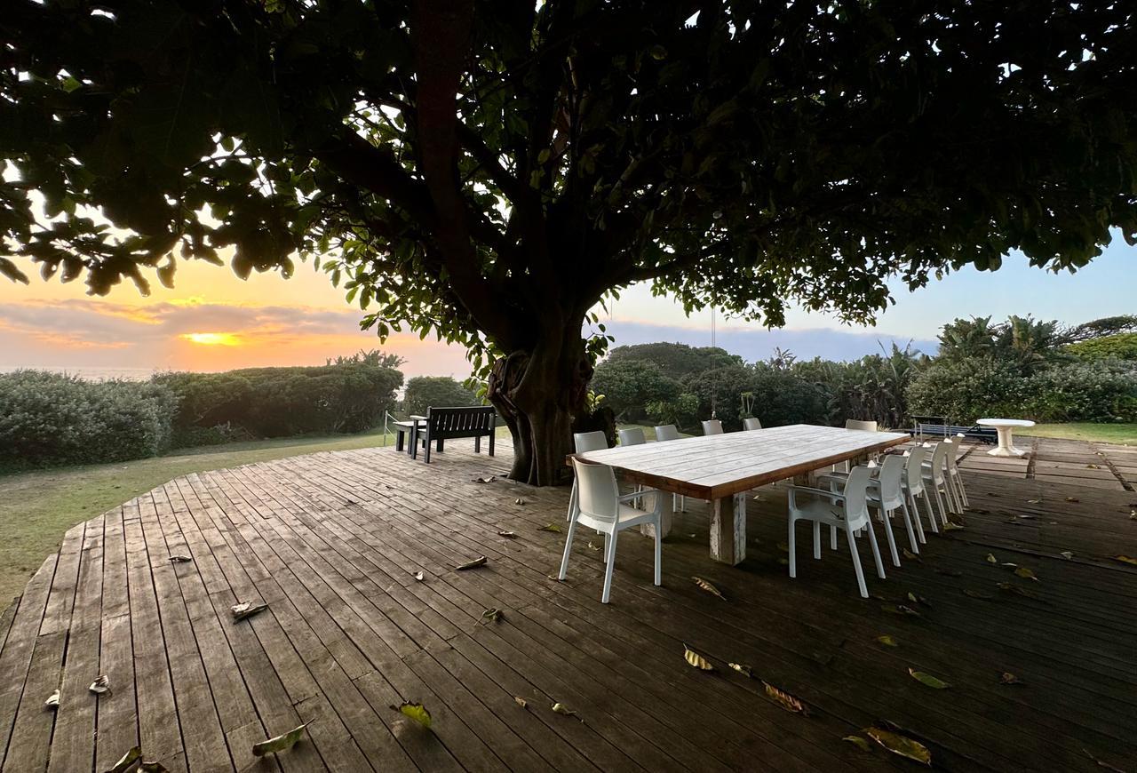 Dining deck under the tree at sunset, Umzumbe Surf Camp