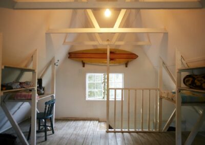 Loft with bunk beds in an A-frame bungalow at Umzumbe Surf Camp
