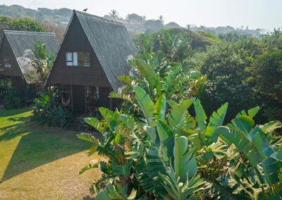 A-frame bungalows in the garden at Umzumbe Surf Camp