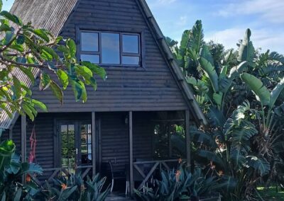 Exterior of an A-frame bungalow at Umzumbe Surf Camp