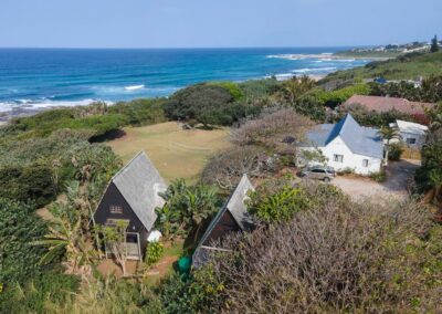 Aerial view of the A-frame bungalows and Surf House at Umzumbe Surf Camp